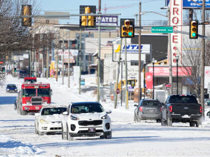 Traffic makes its way along 8th Ave. Tuesday, Jan. 16, 2024, in Nashville, Tenn. A snowsto