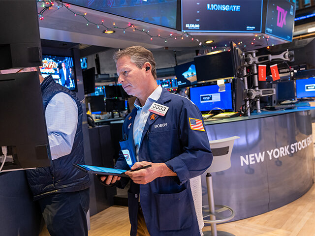 Traders work on the floor of the New York Stock Exchange (NYSE) on the first day back sinc