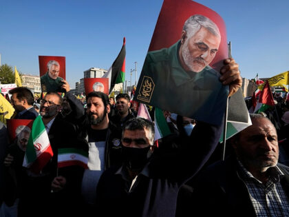 Iranian demonstrators hold posters of the late Revolutionary Guard Gen. Qassem Soleimani,