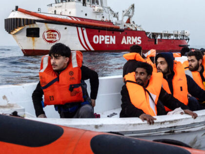 Migrants from Syria and Bangladesh are assisted on January 18, 2024 by a rescue team from