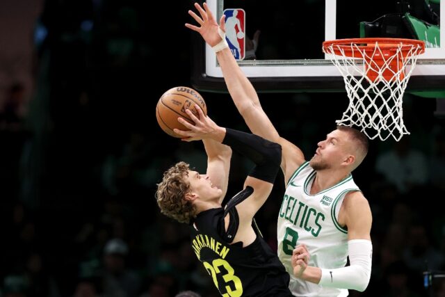 Boston's Kristaps Porzingis defends a shot from Lauri Markkanen in the Celtics' NBA victor