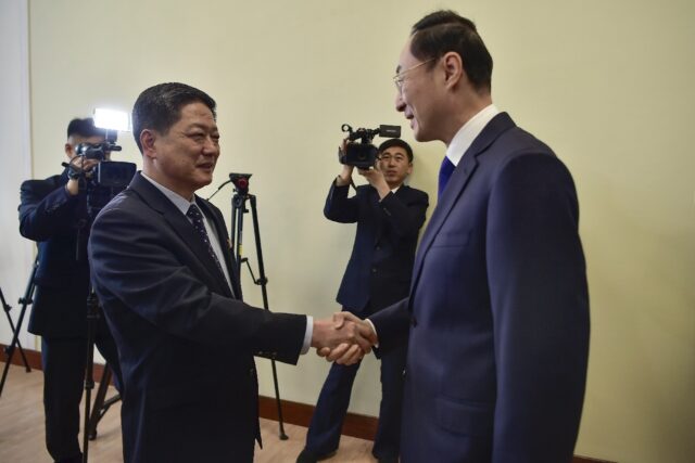 China's Vice Foreign Minister Sun Weidong (R) shakes hands with North Korea's Vice Foreign