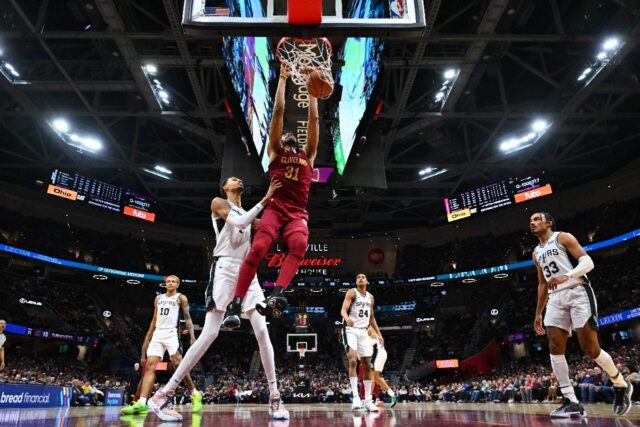 Cleveland's Jarrett Allen dunks over Victor Wembanyama of the San Antonio Spurs in the Cav