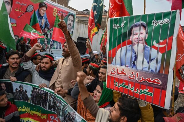 Dozens of supporters of Imran Khan's Pakistan Tehreek-e-Insaf party shout slogans during a