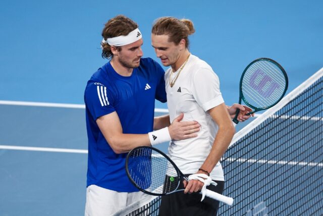 Germany's Alexander Zverev (R) shakes hands with Greece's Stefanos Tsitsipas at the United