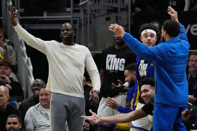 Golden State's Draymond Green reacts with teammates as he watches the Warriors' loss to Mi