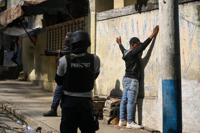 Haitian police arrest a man in the Turgeau commune of Port-au-Prince during gang-related v