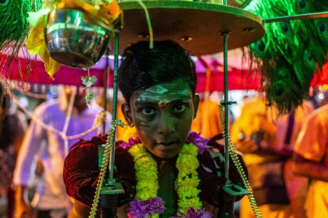 A young Hindu devotee carries "kavadi" on his shoulders as he makes his way towards the Ba
