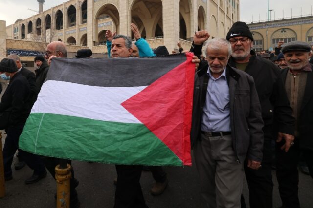 Iranians with a Palestinian flag demonstrate in support of Yemen and Palestinians after Fr