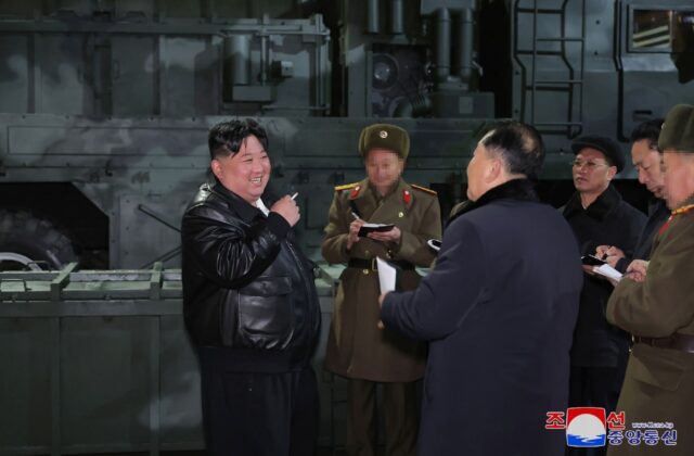 Kim Jong Un (L), seen inspecting a munitions factory, has called for constitutional change