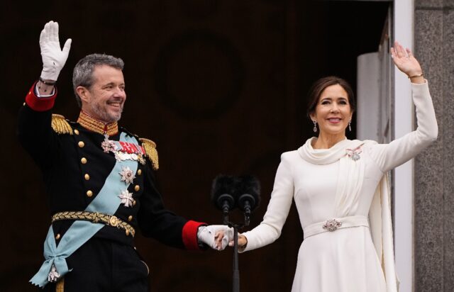 King Frederik X and Queen Mary wave from the balcony of Christiansborg Palace in Copenhage