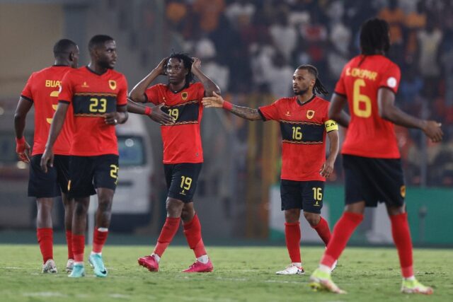 Mabululu, Angola's number 19, celebrates scoring his team's equaliser against Algeria from