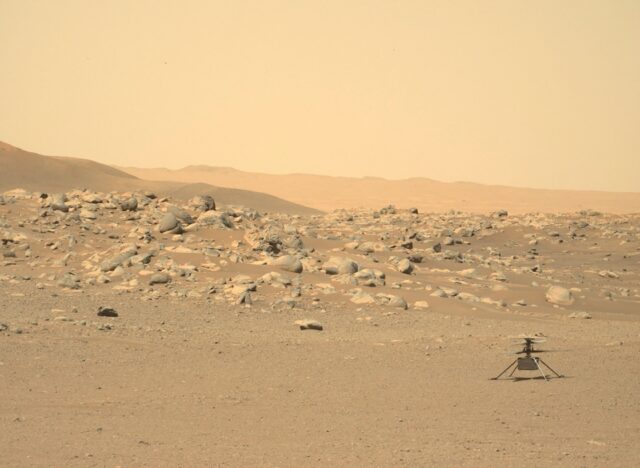 NASA's tiny Ingenuity helicopter is seen sitting on the surface of Mars in a photograph ta