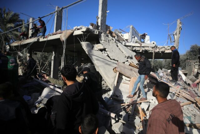 Palestinians inspect the rubble of a house in Deir al-Balah on Tuesday after an Israeli st