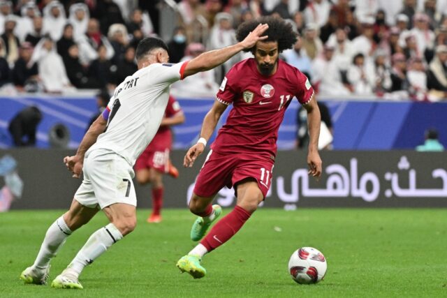 Qatar's forward #11 Akram Afif and Palestine's defender #07 Musab al-Battat during the mat