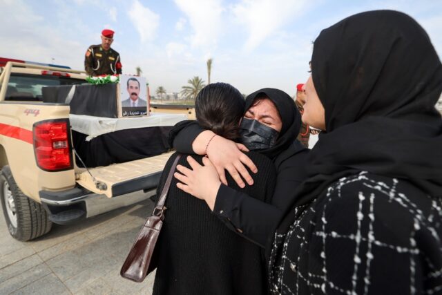 Relatives mourn during a solemn funeral ceremony for the 41 victims from the Yazidi minori