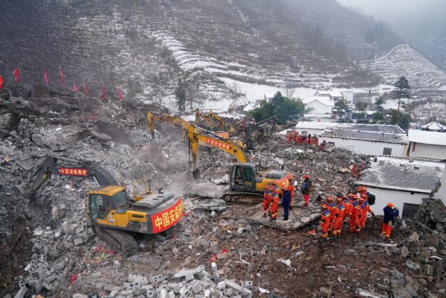 Rescue workers search for missing victims at a landslide site, a day after it hit Liangshu