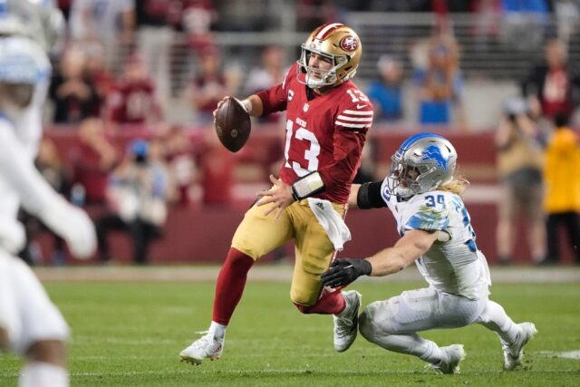 San Francisco 49ers quarterback Brock Purdy evades a tackler during his team's NFC Champio