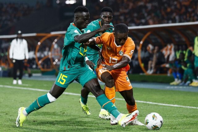 Senegal's Krepin Diatta (L) challenges Max-Alain Gradel of Ivory Coast during Monday's Afr