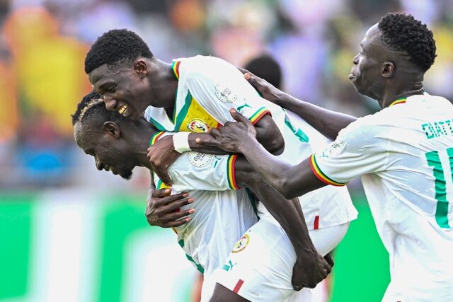 Senegal's Lamine Camara (C) celebrates with teammates after scoring against Gambia at the