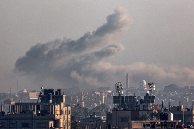 Smoke billows over Khan Yunis in the southern Gaza Strip during Israeli bombardment on Jan