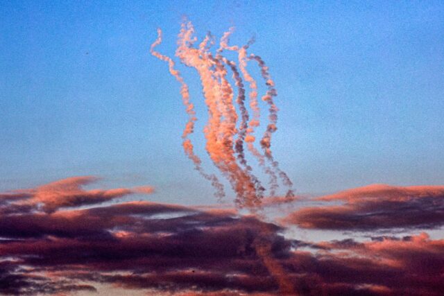 Smoke plumes trail from a salvo of rockets fired towards Israel, pictured from the souther