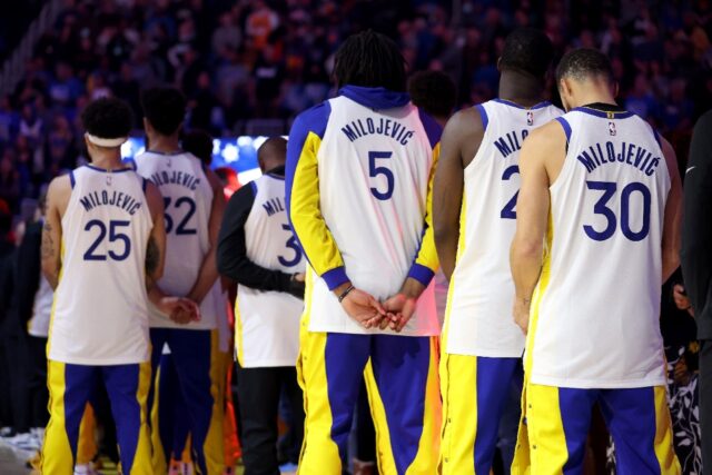 Stephen Curry, right, and other players on the Golden State Warriors wear the name of the