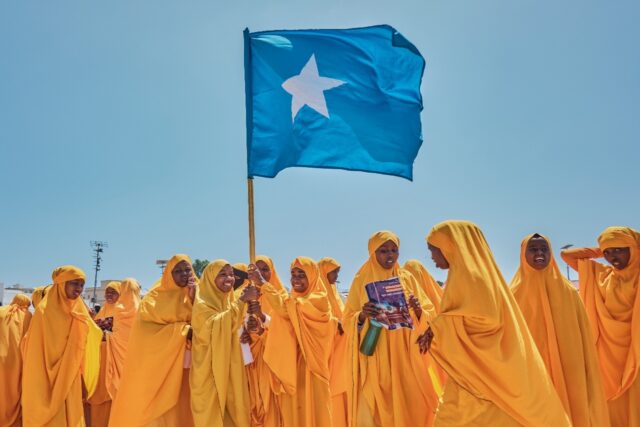 Students wave a Somali flag during a demonstration in support of the government over the c