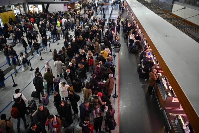 Travellers queue up at Pristina International Airport after a new EU visa scheme came into