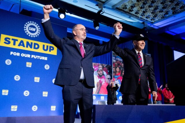 US President Joe Biden and Shawn Fain, President of the United Auto Workers (UAW), wave du