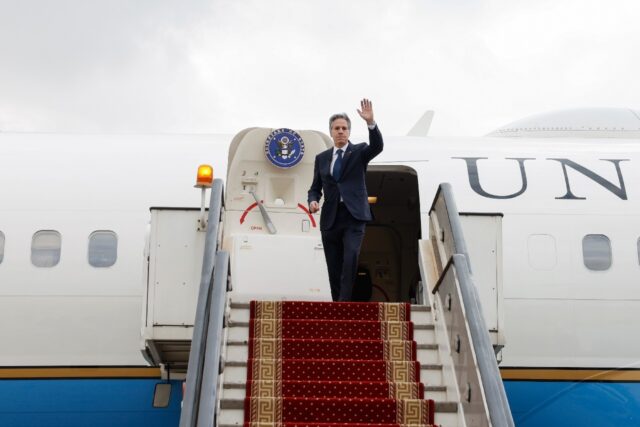 US Secretary of State Antony Blinken waves as he flies out of Cairo as on January 11, 2024