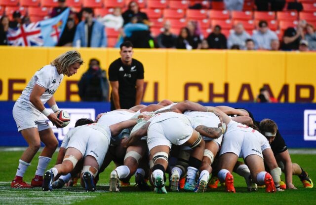 The USA Eagles, in a scrum against New Zealand during a 2021 men's rugby contest, stand to