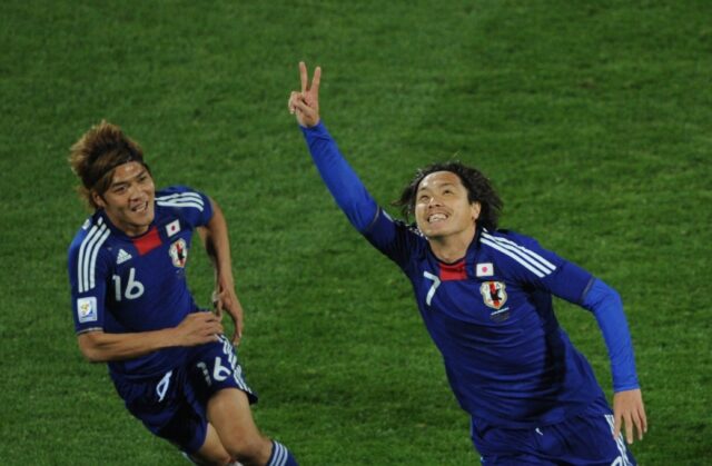 Yasuhito Endo (R) celebrates with Yasuhito Okubo after scoring as Japan beat Denmark at th