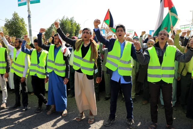 Yemenis wave Palestinian flags as they chant anti-Israel and anti-US slogans during a prot
