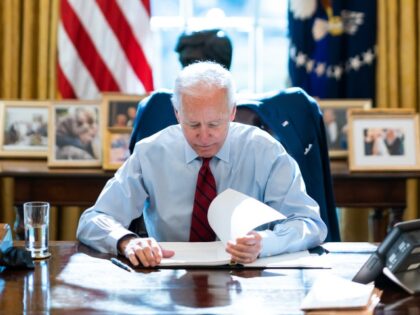 President Joe Biden reviews his notes Thursday, Jan. 28, 2021, in the Oval Office of the W