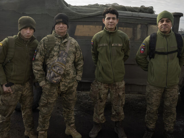 Colombian veterans who joined the Ukrainian armed forces to help fight Russia pose for a p