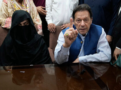 Pakistan's former Prime Minister Imran Khan, right, and Bushra Bibi, his wife, speak