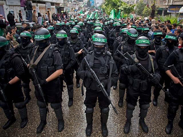 In this Dec. 14, 2014, file photo, masked Palestinian gunmen of the Hamas militant group h