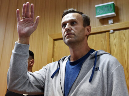 TOPSHOT - Russian opposition leader Alexei Navalny gestures during his trial at a Moscow c