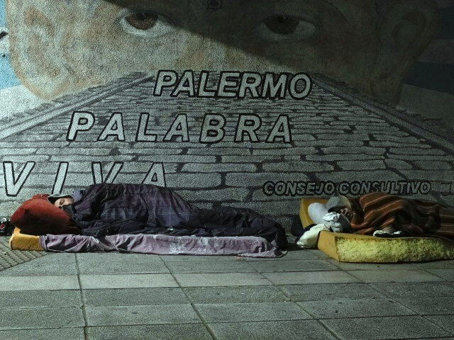 Homeless people sleep on a sidewalk in Buenos Aires, Argentina, Wednesday, early Sept. 27,