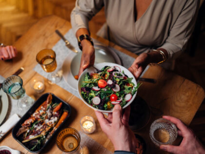 A bowl of salad is being offered at dinner (Stock photo via Getty).
