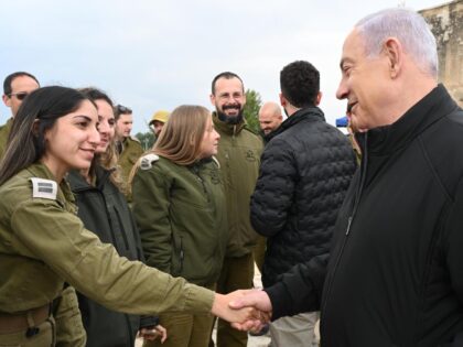 Israeli Prime Minister Benjamin Netanyahu greets a female IDF soldier at Latrun, Israel, F