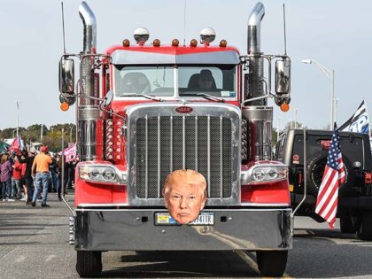A truck with a picture of Donald Trump drives through a pro-Trump rally on October 11, 202