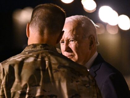 US President Joe Biden speaks with a soldier upon arrival at Dover Air Force Base in Dover