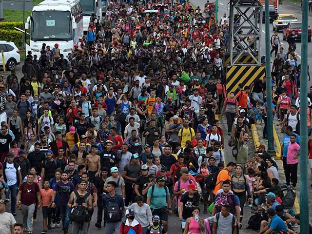 Latin American migrants take part in a caravan towards the border with the United States, in Huehuetan, Chiapas state, Mexico, on June 7, 2022. - President Joe Biden's plans to reboot US engagement with Latin America -- especially on critical topics like migration -- took a hit after key partner …