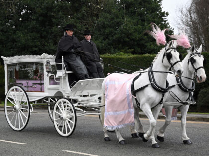 The horse-drawn carriage transporting the coffin of murdered transgender teenager Brianna