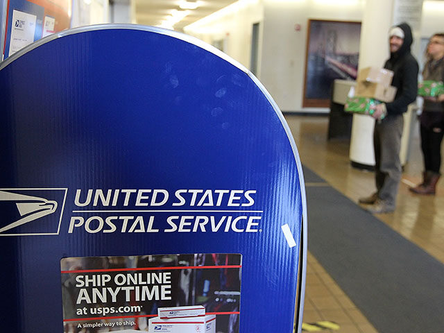 Customers wait in line to ship packages at a US Post Office on December 5, 2011 in San Fra