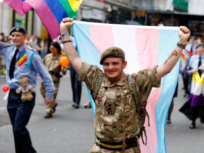 LONDON, ENGLAND - JULY 01: A member of the British Army carries a transgender flag during