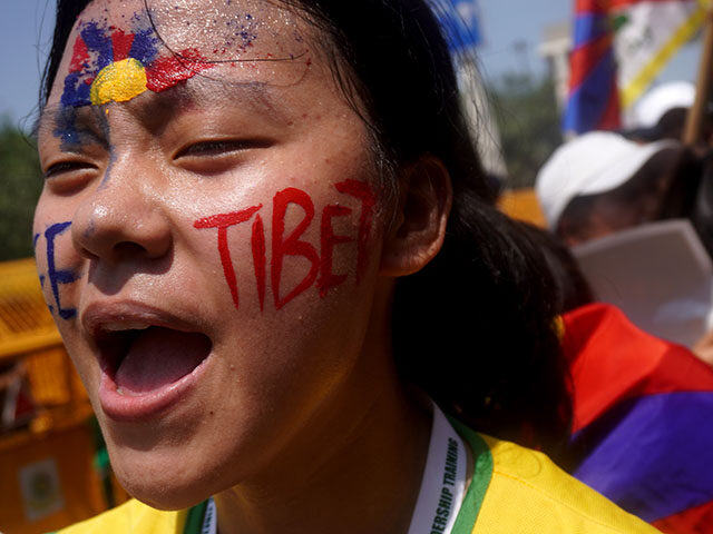 A Tibetan community member shouts slogans while demonstrating a protest against China&#039