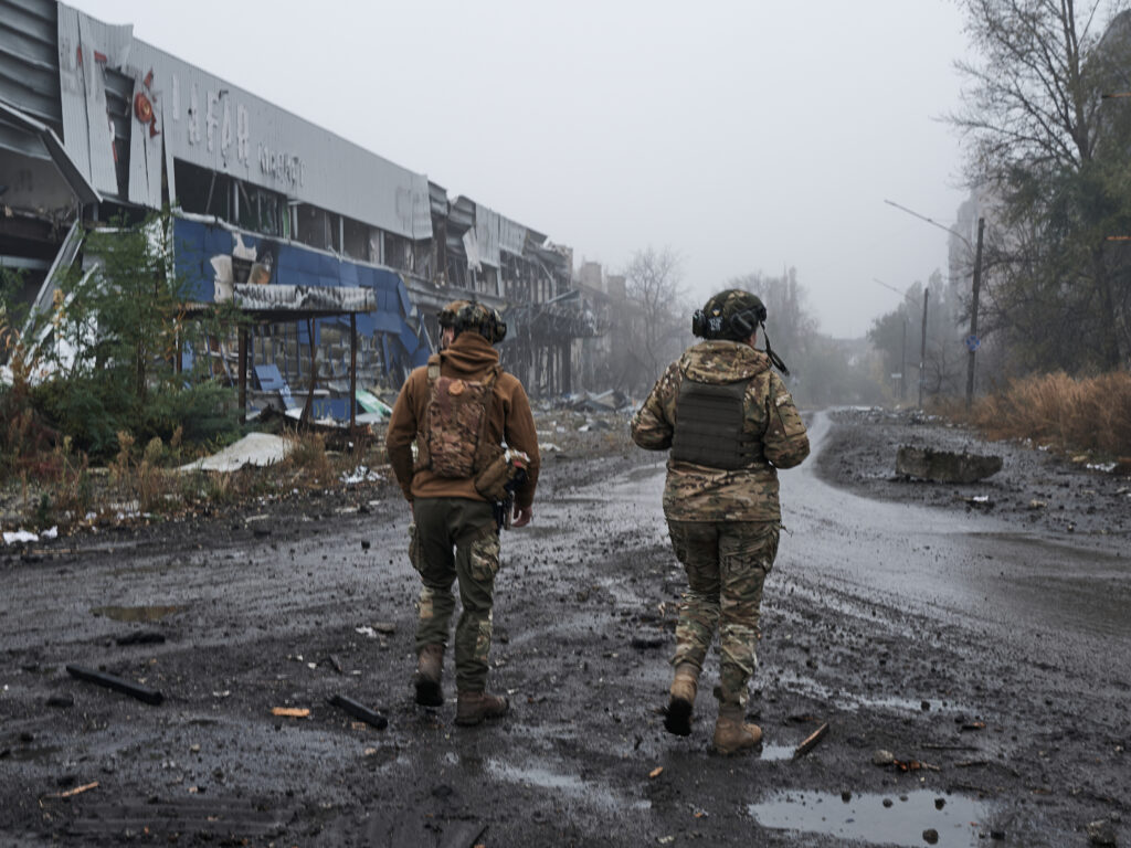 AVDIIVKA, UKRAINE - OCTOBER 26: Two Ukrainian soldiers walk along the destroyed city in the fog on October 26, 2023 in Avdiivka, Ukraine. Fighting has intensified in recent days after Russia launched a major offensive here earlier this month. (Vlada Liberova / Libkos via Getty Images)